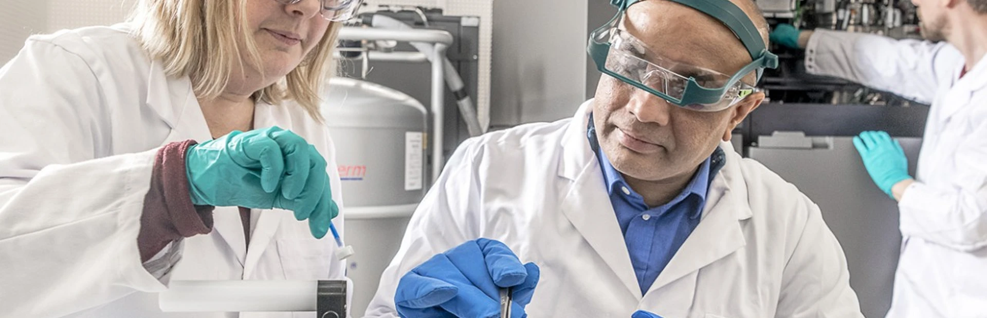 Scientists from Novartis and the Friedrich Miescher Institute prepare a sample forscreening by a cryo-electron microscope. Scientists prepare a sample for imaging by a cryo-electron microscope.