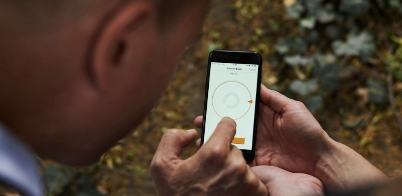 Person shows phone functionality to another individual Individual interacts with digital technology via mobile phone